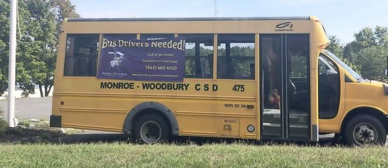 A Monroe-Woodbury school bus advertising a help wanted ad for bus drivers