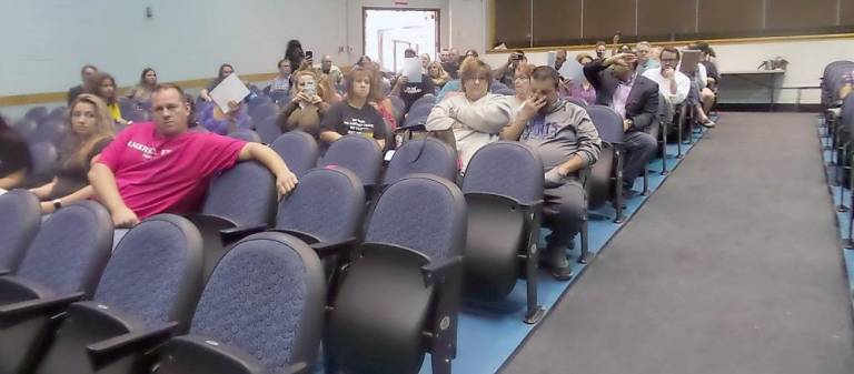 People without masks were asked to sit on the right side of the high school auditorium during the meeting (Photo by Frances Ruth Harris)