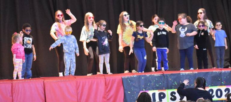 Special education teacher Ms. Sudano leads her class in performing Snoop Dogg’s “The Affirmations Song.” Younger students Hailey McAllister, Quentin Davis, Colin Wilson, Autumn Breen, Leah Luttke, Zay’ Vien Gonzalez, Savannah Kunis, Raelynn Padgett and Zarion Singh are joined by fifth graders (back row) Maddie Latini, Hazel Pope, Gia Cosentino, Bella Bailey and Jodie Harrison.