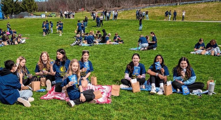 Residents gather to view partial solar eclipse Students snack on Sun Chips, Starbursts and Moon Pies. (Photo by Nancy Madacsi)