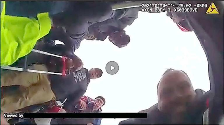 Ex-NYPD officer and Marine charged in violent Capitol attack Federal authorities said Thomas Webster, pictured in the lower right, lunges at the officer and tackles him to the ground. Authorities said the assault on the ground lasts approximately ten seconds.
