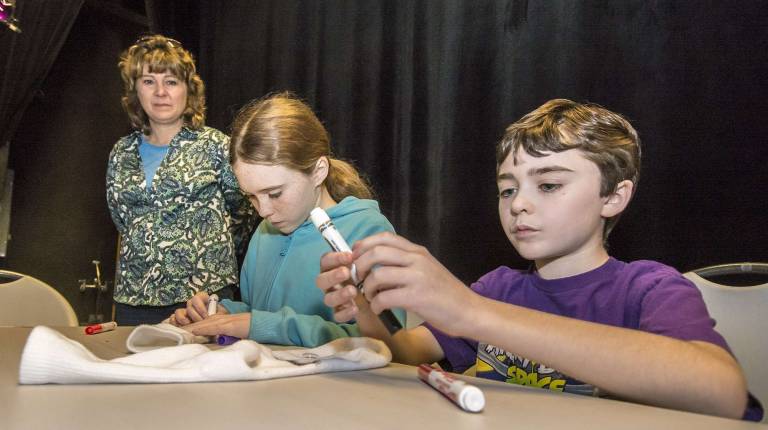 Sock puppet fun (L-R) Mom Meg Gummere of Vernon and her kids Emma, 12, and Patrick, 10.