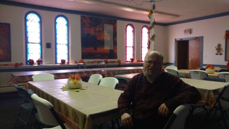 'Just come': Volunteer explains origin of annual Thanksgiving feast Volunteer Steve Davis sits in the church hall, decorated for the coming Thanksgiving feast (Photo by Anya Tikka)