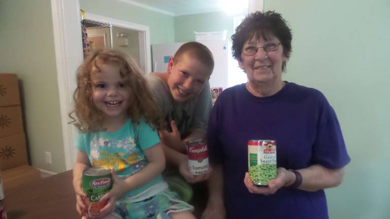 Pantry packs boxes of sunshine for Pike seniors Saige Davis and Sherman Williams helped Kathy Baker of Milford with her sunshine box (Photo by Frances Ruth Harris)