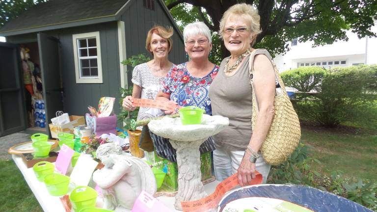 Milford's gardens, revealed At Remembrance Place, the hidden jewel of Milford. Located at the far end of Ann Street, it holds a variety of gardens dedicated to perennial plants native to the area. Marcia Monaco, Joyce Van Nest, Helga Becking are busy at the raffle-select-your-prize table just prior to the tour.