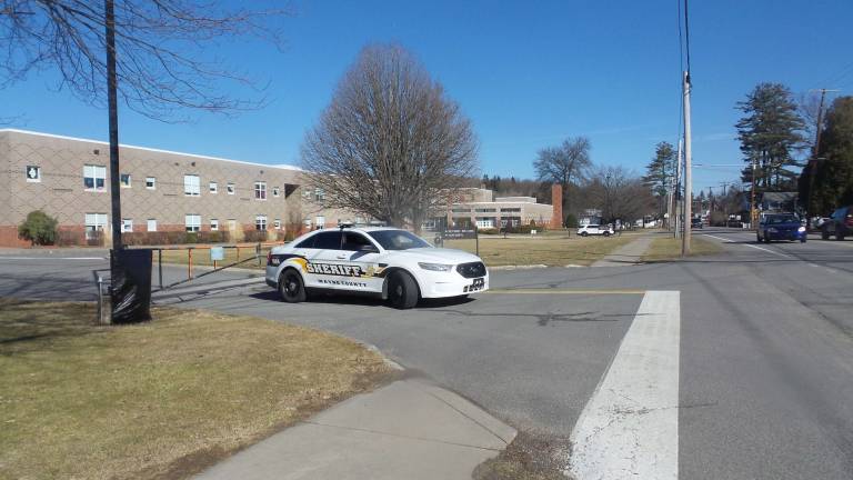 Gun-wielding couples renew their vows Three police cars were parked at the three entrances of the Wallenpaupack Elementary School, which was empty on the day of the church blessings (Photo by Frances Ruth Harris)