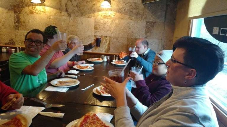 Devereaux visitors learn pizza business from a pro Visitors from Devereux Tristate Adult Day Care enjoy pizza with BJ Horning, branch support specialist (Photo by Anya Tikka)