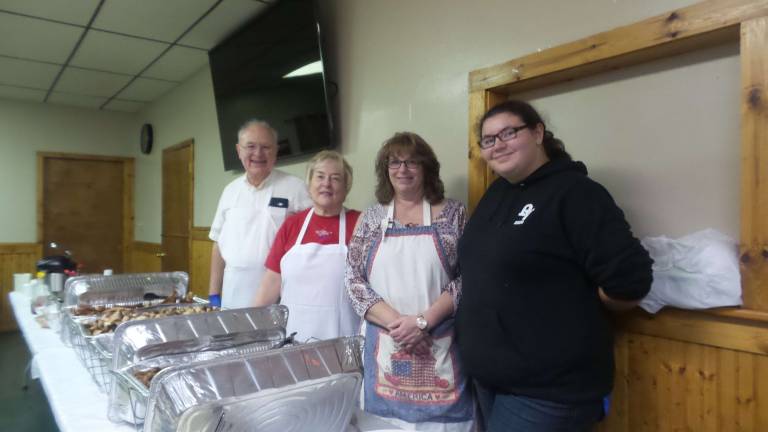 'Our freedom will never be free' Neil Frazer, Barbara Meyer, Christine Protsko, and Terri Koch served a delicious breakfast (Photo by Frances Ruth Harris)