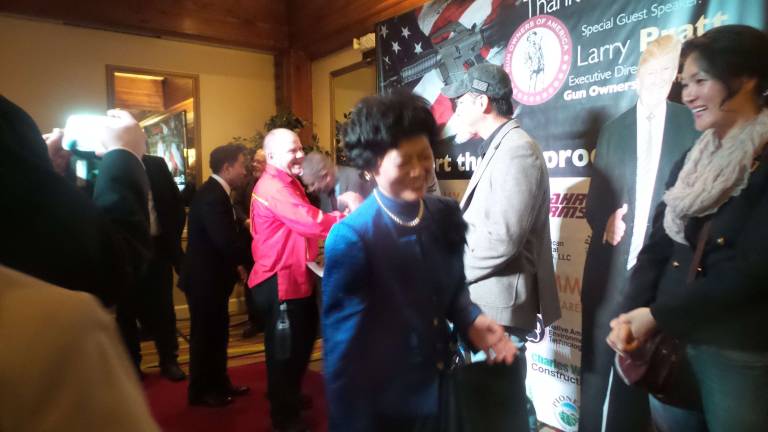 More guns means a safer society, dinner guests say The Rev. Hyung Jin Moon and his wife, Yeon Ah Lee Moon, dispense smiles and hugs as the reception line moves forward (Photo by Frances Ruth Harris)