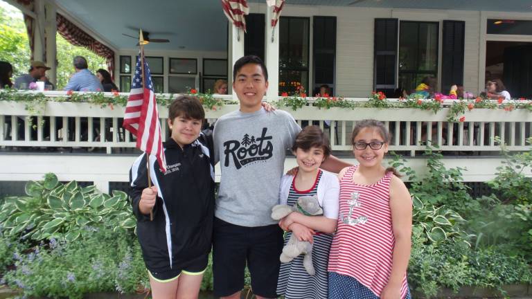 Milford honors those who sacrificed all From left: Sidney Garrison; Takun Li, a Delaware Valley exchange student from Tiawan; Maya Garrison; and Christa Cirello (Photo by Frances Ruth Harris)