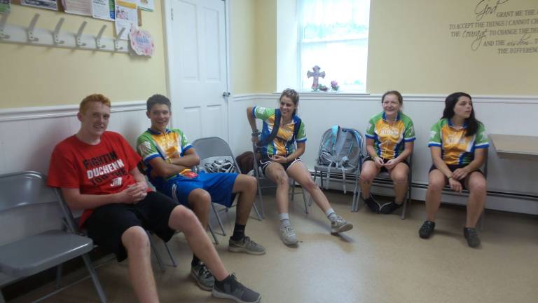 Teen riders stop in Milford during 18-day ride for Duchenne Muscular Dystrophy After chalking up 66 miles on Saturday, July 21, the riders relax for a moment before going for a swim. All are 15, 16, 17 or 18 years old, with several leaders just a few years older. Dinner in Fellowship Hall followed their swim. They were up at 4:30 a.m. to begin cycling again for Duchenne Muscular Dystrophy. (Photo by Frances Ruth Harris)