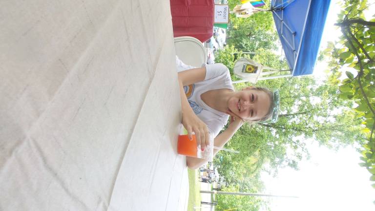 Milford gets fresh Natalia Piwowarczyk sipped strawberry-rubarb juice. She said, “I got it last year and it was really good!” (Photo by Frances Ruth Harris)