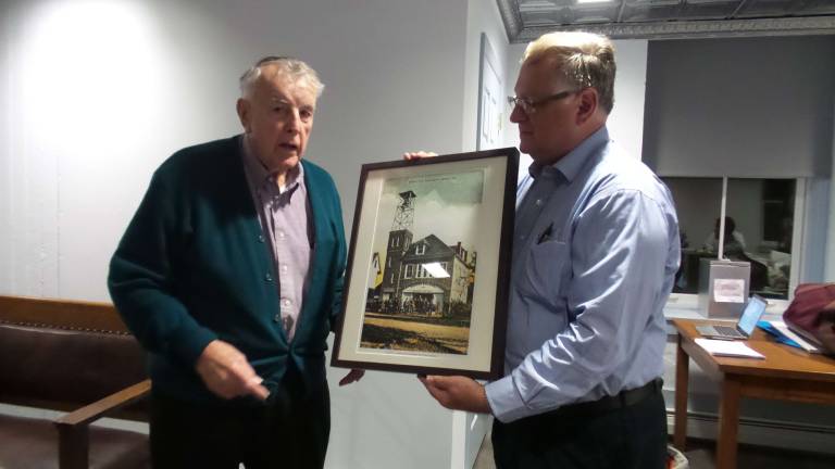 Testy meeting hints at revolution to come Skip Gregory presents image of Milford Borough Hall to Joe Camus, during a break in the tension (Photo by Frances Ruth Harris)