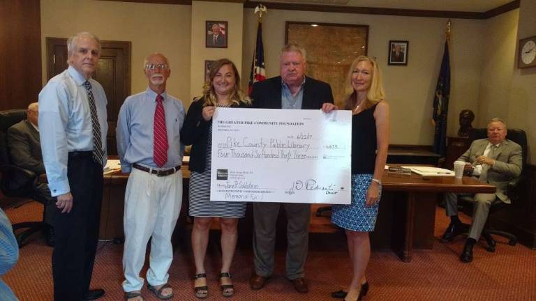 Library and United Way get boost from donations Pike County Public Library's Executive Director, Rose Chiocchi (third from left), receives a check for $4,633 from Pike County Community Foundation Chair Jim Perdanti (Photo by Anya Tikka)