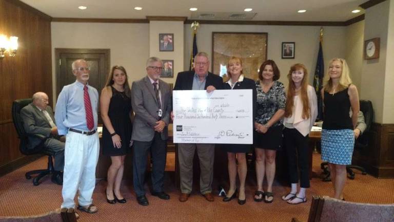Library and United Way get boost from donations United Way of Pike County's President, Matt Osterberg (third from left),receives a check for $4,633 from Pike County Community Foundation Chair Jim Perdanti (Photo by Anya Tikka)