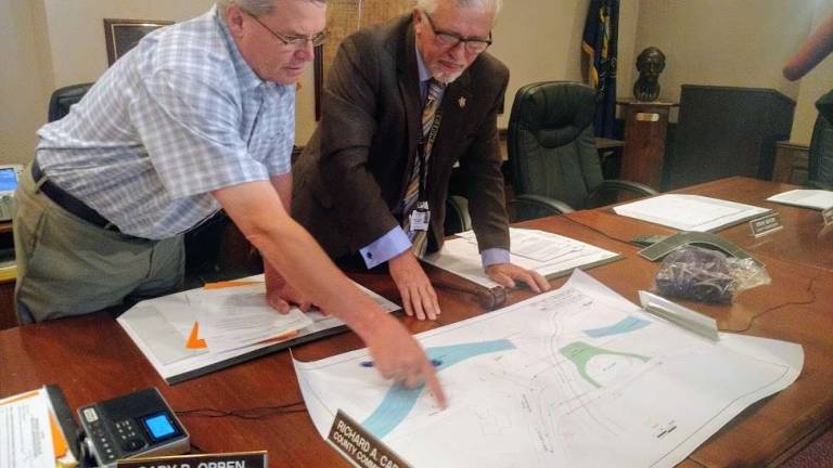 Commissioners Chair Matt Osterberg (right) studies the map of Route 209 (Photo by Anya Tikka)