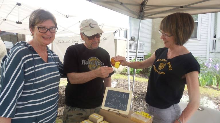 Milford gets fresh Ciro Matrecano went for a sample of Branble Ridge Honey Farm’s smooth honey. His wife, Felicita, waits her turn at a sample. Pam Lavelle made it all happen at The Milford Framers Market on May 28. (Photo by Frances Ruth Harris)