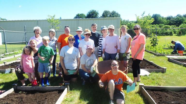 Garden club plants, weeds, and harvests to feed the hungry Pantry volunteers, garden club members and Home Depot volunteers at the community garden (Photo by Frances Ruth Harris)