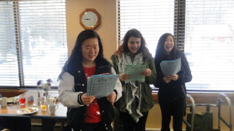 Integrated class bakes and sings for nursing home residents Pictured caroling are (from left): Mandy Xu, Paige Collins, and Tess Balton (Photo provided)
