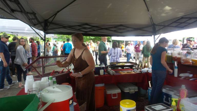 Milford gets fresh Milford Farmers Market operated all-the-way-live on May 2. The band played. A breeze melted the heat. People walked away with food and flowers. Many said they had so looked forward to the day. (Photo by Frances Ruth Harris)