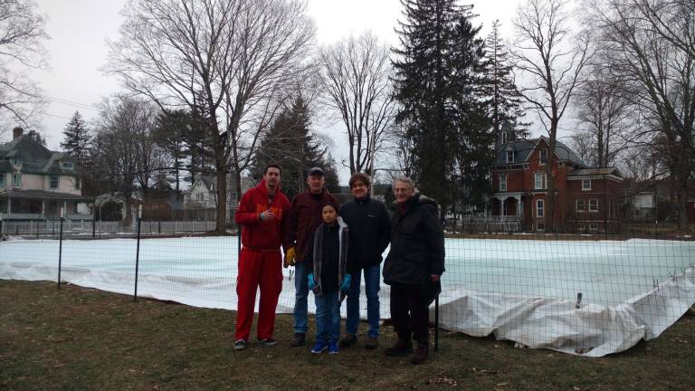 Festival breathes life into the 'dead of winter' In front of the ice rink in progress are: Bradlee and dad Scott Sheldon, Mike Zimmerman and Mike Carson, with Abbey Zimmerman in front (Photo by Anya Tikka)