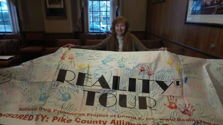 Tour delivers a hard dose of reality about drugs Director Jill Gamboni with the Realty Tour banner (Photo by Frances Ruth Harris)