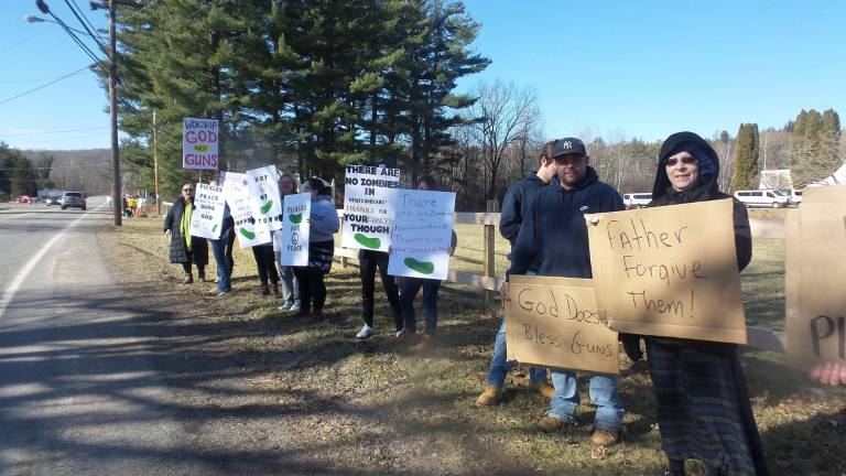 Gun-wielding couples renew their vows Protestors outside the church (Photo by Frances Ruth Harris)