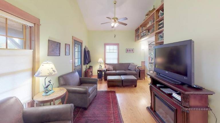 Custom three-bedroom on secluded, historic acre with lake rights Living room