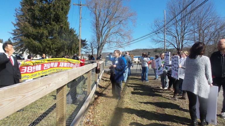 Gun-wielding couples renew their vows Protesters carrying signs that said things like "Father, forgive them" and "Shame!" clashed with worshippers at the blessing ceremony (Photo by Frances Ruth Harris)