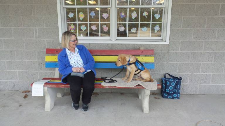 Benni, service dog in training, dazzles preschoolers Chrisanne Cubby and Benni wait outside Kids Play Today for their usual Monday visit to start (Photo by Frances Ruth Harris)