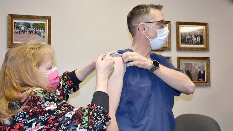 Michelle Corrigan, RN, vaccine co-coordinator/WMCHC, administers a Covid-19 vaccine to Sean McVeigh, MD, pulmonologist and medical director Wayne Memorial Covid Task Force (Photo provided)