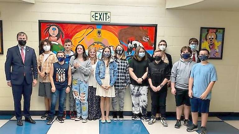 In the front row (from left): Consul General David Gill, Alexander Kaufmann, Irelyn Roberts, Julia Brzenia, Keenan McHenry, Maddox Rhodes, Finnegan Lewis. Back: Robert Kim, Logan Tarquini, Kayleigh Jagger, Mylie Linton, Jessie Chopyk, Mrs. Miller, and Gabriel Wagner. (Photo provided)