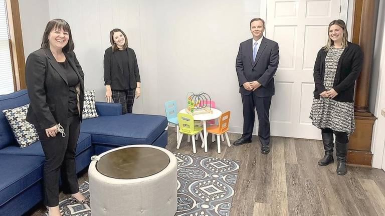 Reception room of Corporal Bryon Dickson's Child Advocacy Center at its grand opening last November (from left): Sarah Wilson, Director of CAC Services; Molly Carson, MDIT Coordinator/Forensic Interviewer; District Attorney Ray Tonkin; and Sara Loeb, Special Victim Interviewer (Photo provided by Sarah Wilson)