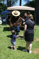 A child and his mother greet Smokey the Bear at the 15th Zane Grey Festival.