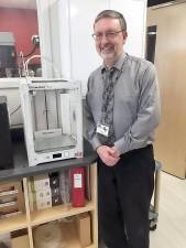 Robert Curtis, who teaches Advanced Placement physics, astronomy, and engineering , with a 3-D printer at Delaware Valley High School