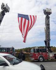 Fire trucks from Honesdale hold Old Glory aloft (Photo by Ken Hubeny Sr.)