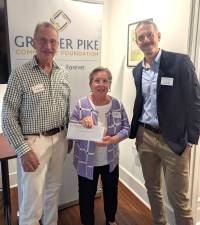 Rick Little (right), executive director of Greater Pike Community Foundation, presents a check to Ecumenical Food Pantry volunteers Jim Snodgrass (left) and Allyson Gillinder (middle).