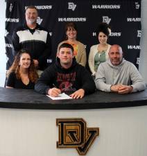 Pictured in front: Senior Delaware Valley senior Justin Hernandez is flanked by his mother, Stefanie (left), and his father, Andre. Behind them, from left to right, are: Head football coach and assistant track coach Keith Olsommer, guidance counselor Molly Blaut and high school principal Dr. Nicole Cosentino. Photo provided by Leslie Lordi/Delaware Valley School District.