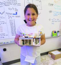 DVES fourth grader Olivia Graziano with the LEGO house she built modeled after her family’s home.