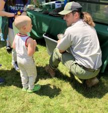 A young visitor leans about turtles of the Delaware River at the 18th Zane Grey Festival.