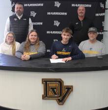 DVHS senior Keegan Samson signs a letter or intent to Centenary University as (bottom row l-r) his sister Chelsea Samson, mother Lisa Samson, father Andrew Samson, Eastern Pike coach Chris Decker (rear left) and varsity head coach Aaron Stark (rear right) look on.
