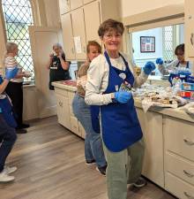 Volunteers Emily &amp; Donna prepare dessert platters at the May lunch.