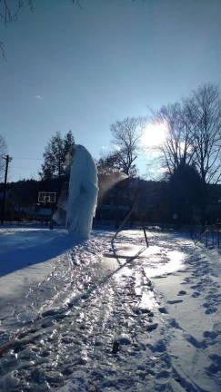 Tom Holmes's ice sculpture is taking shape at the Ann Street Park rink. “It’s a give and take between mother nature and Tom,” joked organizer Mike Carson. (Photo by Anya Tikka)