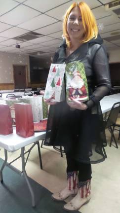 The president of Milford’s American Legion Auxiliary, Katie Jo Kardel, packed gifts at the American Legion Auxiliary, then personally delivered them to more than veterans at Milford Senior Center and Belle Reve Senior Living Center on Dec. 27. (Photo by Frances Ruth Harris)