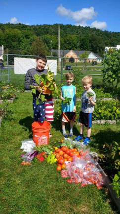 Boy Scouts visit community garden at harvest time