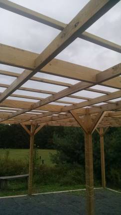 The outdoor classroom under construction. Ivy will grow up around the posts next season to eventually provide a shady roof (Photo provided)