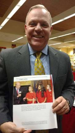 Superintendent John Bell holds up the Association’s magazine with photo of Governor Wolf and DV DVE-TV student reporters (Photo by Anya Tikka)