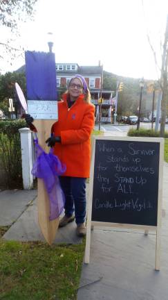 Carol Witschel, president of Safe Haven's board of directors, with one of the brushes illustrating the theme of Safe Haven's annual "Paint Pike Purple" campaign (Photo by Frances Ruth Harris)