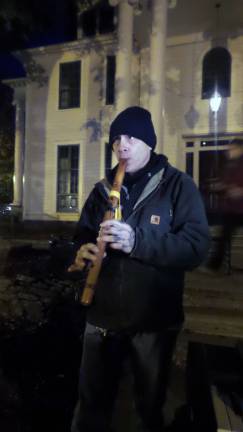 Christopher Gebiya played the flute as candles were lighted and participants stood in silence (Photo by Frances Ruth Harris)