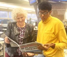 Jeanne Straus (l), publisher of Straus News, looks over a recent issue of the publication with new managing editor, Felicia Hodges.